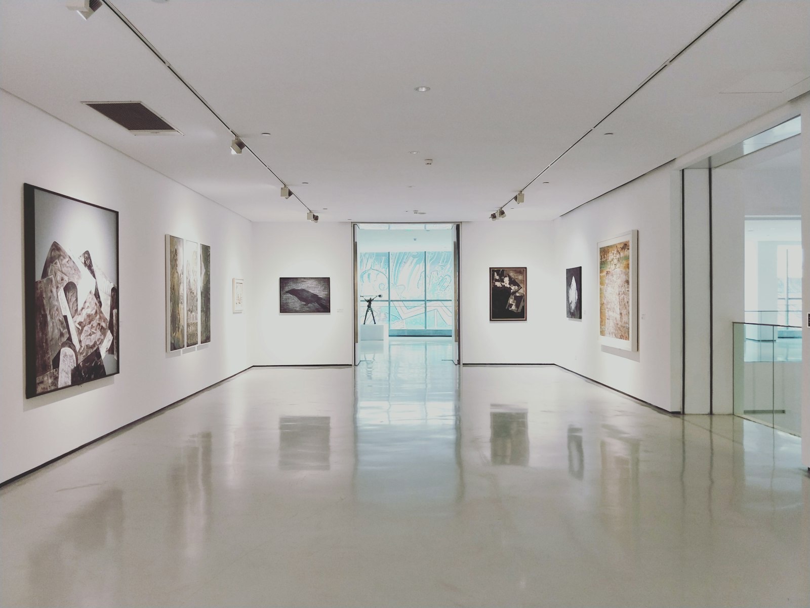 White-walled gallery interior hung with contemporary paintings