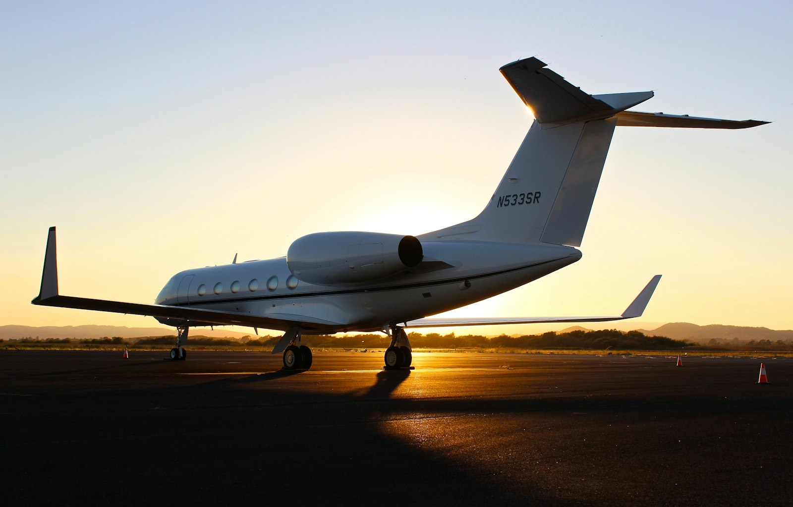 Gulfstream business jet on an airport apron at dusk